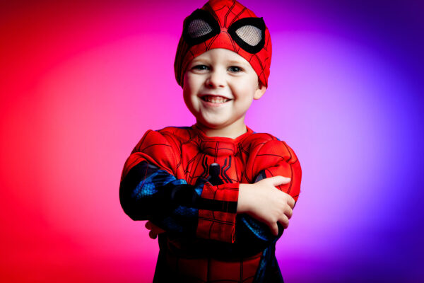 boy dressed as spiderman smiling