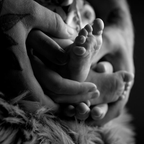 photo of babies feet being held by parent