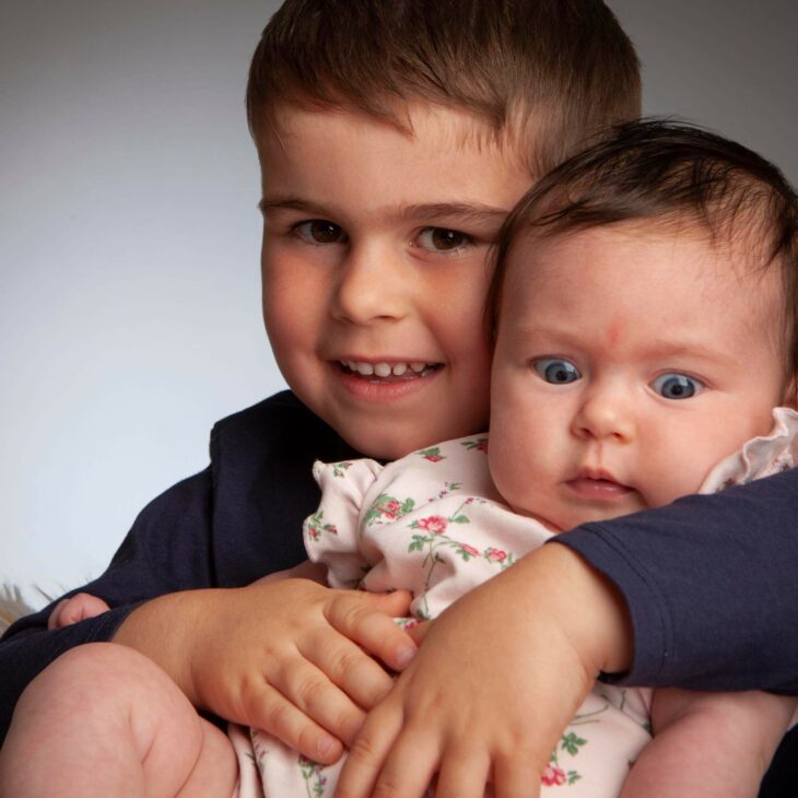 brother holding his little sister photo