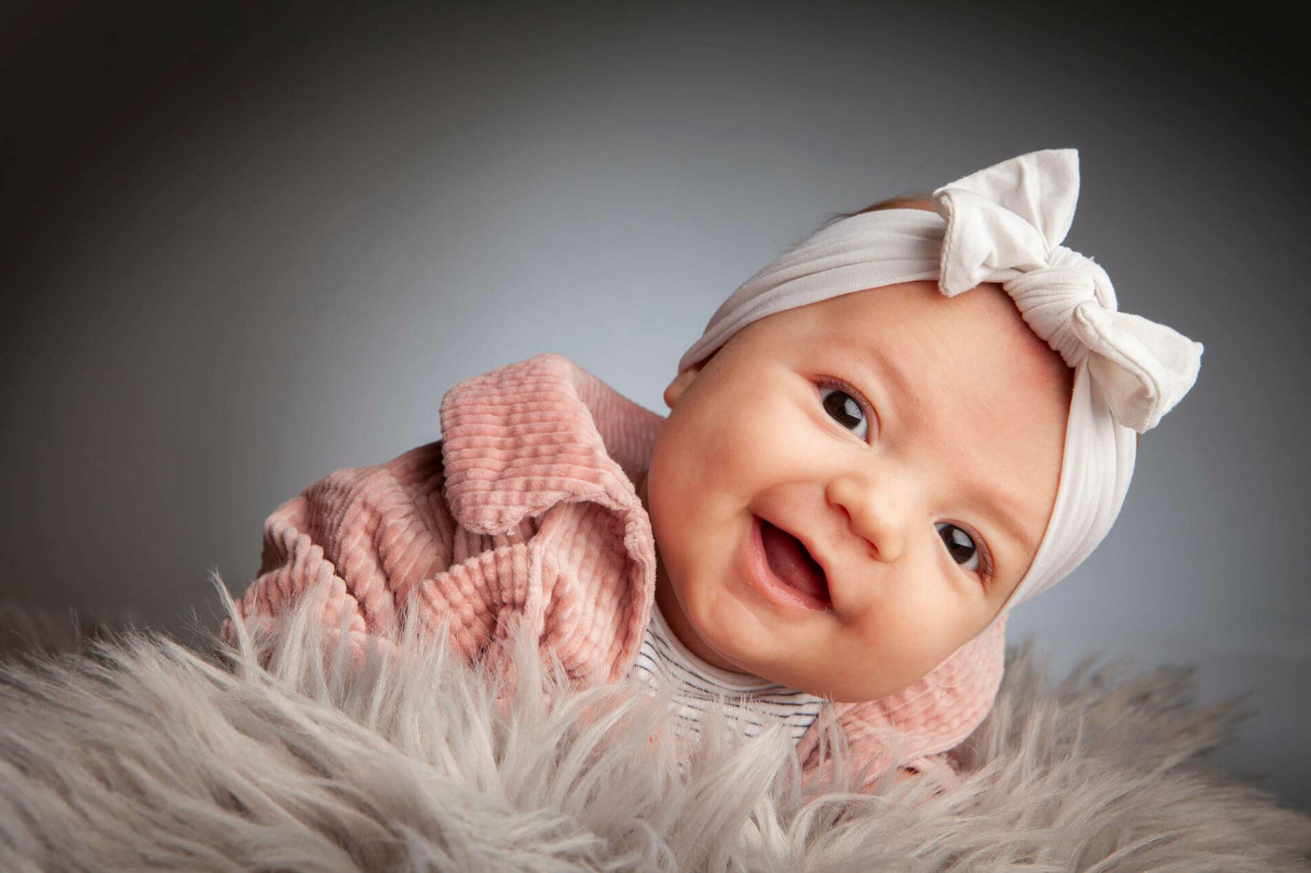 smiling baby girl with white headband