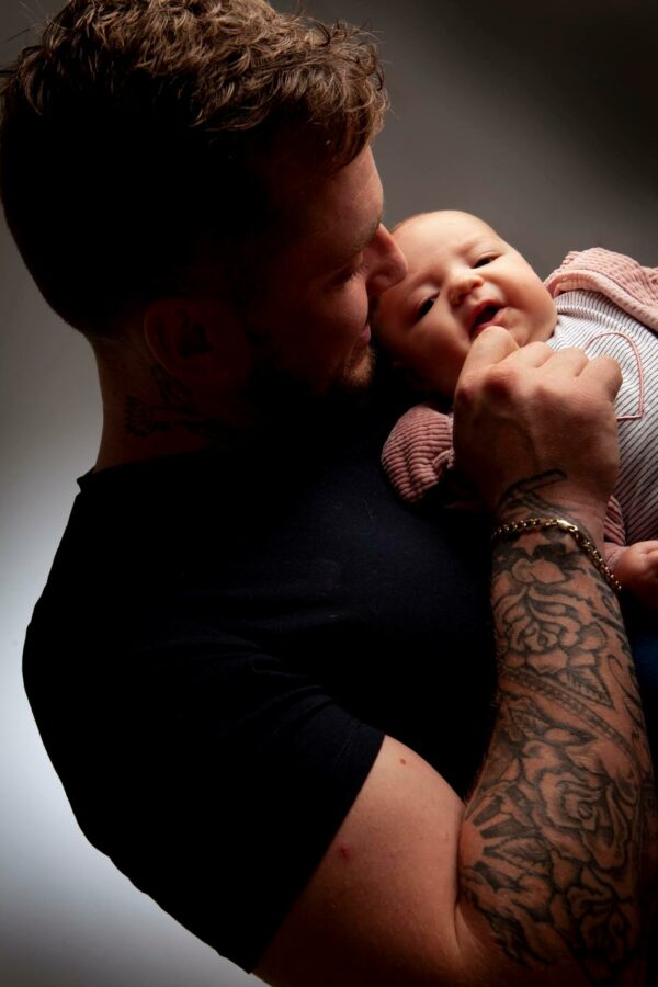 photography of dad holding newborn baby
