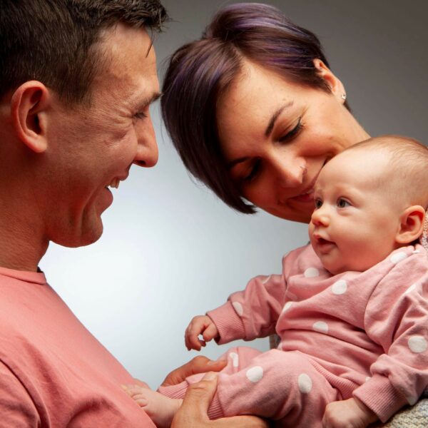 new born baby smiling at parents