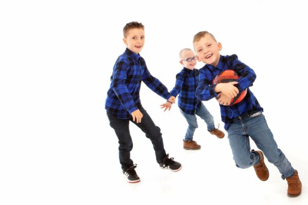 three boys having fun with a football